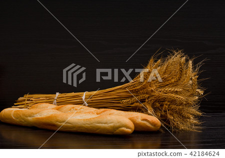 Two white loaf and a sheaf on a black background Two white loaf and a sheaf on a black background 42184624