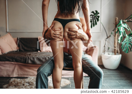 Man is holding a woman's ass, back view on girl 42185629