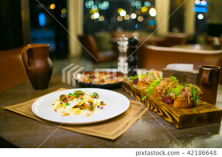 Crepe mushrooms, meat appetizers on cutting board 42186648