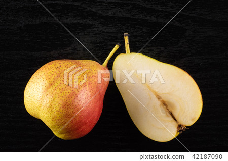 Fresh Raw red pear on black wood Fresh Raw red pear on black wood 42187090