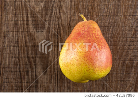 Fresh Raw red pear on brown wood 42187096