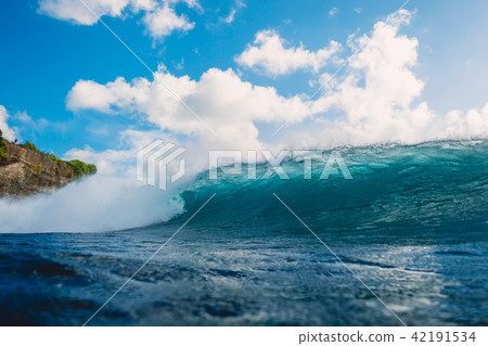Crashing blue wave in ocean. Breaking barrel wave Crashing blue wave in ocean. Breaking barrel wave 42191534