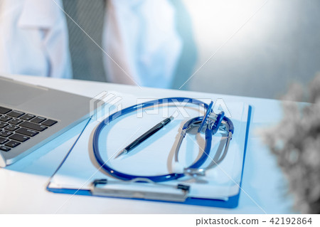 Stethoscope, clipboard and laptop on doctor desk Stethoscope, clipboard and laptop on doctor desk 42192864