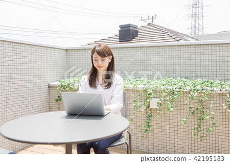 Young lady terrace balcony laptop 42195183