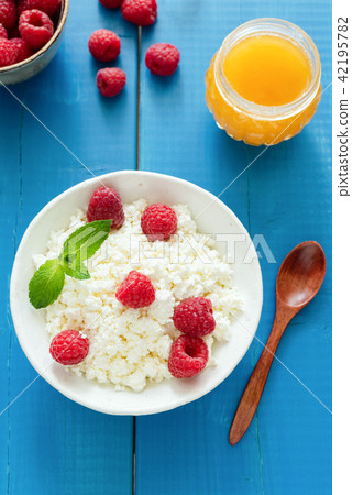 Fresh ricotta or curd cheese with raspberries and honey Fresh ricotta or curd cheese with raspberries and honey 42195782