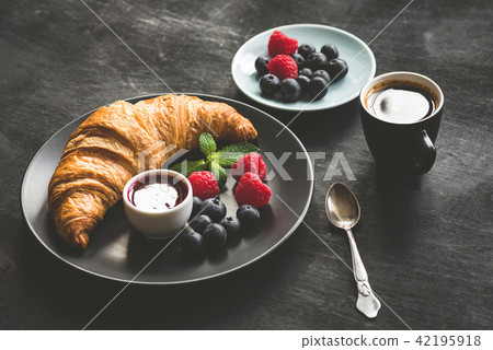 French croissant, berries, jam and coffee 42195918