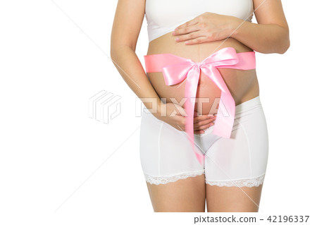 Pregnant woman hands holding belly with blue ribbon gift on bell Pregnant woman hands holding belly with blue ribbon gift on bell 42196337