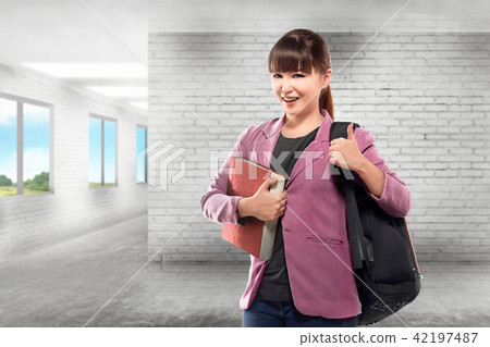 Pretty asian female college student with book 42197487