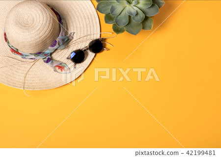 Colorful summer female fashion with hat on yellow background Colorful summer female fashion with hat on yellow background 42199481