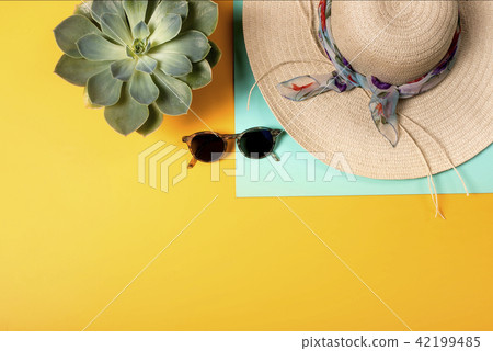 Colorful summer female fashion with hat on yellow background Colorful summer female fashion with hat on yellow background 42199485