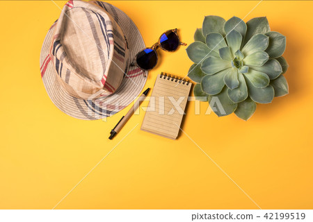 Colorful summer female fashion with hat on yellow background Colorful summer female fashion with hat on yellow background 42199519