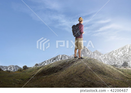 Rear view of asian traveler standing and enjoying Rear view of asian traveler standing and enjoying 42200487