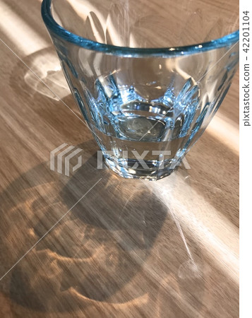 Partly drunk mineral water in a blue glass Partly drunk mineral water in a blue glass 42201104