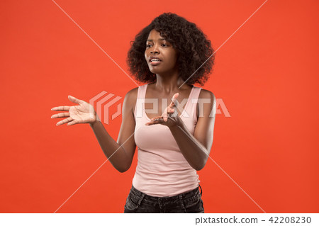Beautiful female half-length portrait isolated on red studio backgroud. The young emotional Beautiful female half-length portrait isolated on red studio backgroud. The young emotional 42208230