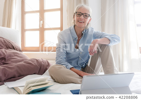 Senior woman freelancer in her study with computer 42208806