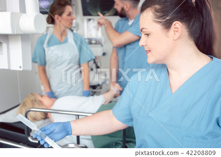Team of nurses and doctors preparing for endoscopy examination Team of nurses and doctors preparing for endoscopy examination 42208809