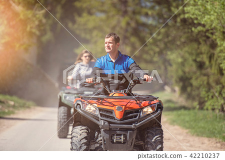man riding atv vehicle on off road track ,people outdoor sport activitiies theme 42210237