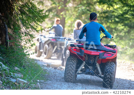 man riding atv vehicle on off road track ,people outdoor sport activitiies theme 42210274