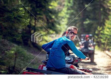 man riding atv vehicle on off road track ,people outdoor sport activitiies theme 42210280