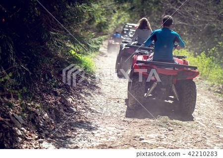 man riding atv vehicle on off road track ,people outdoor sport activitiies theme 42210283