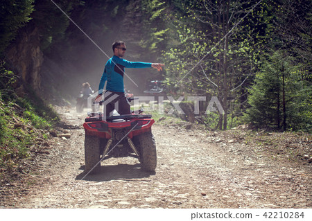 man riding atv vehicle on off road track ,people outdoor sport activitiies theme 42210284