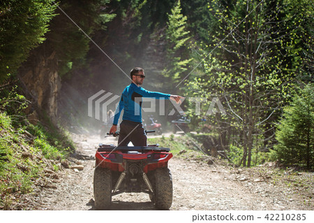 man riding atv vehicle on off road track ,people outdoor sport activitiies theme man riding atv vehicle on off road track ,people outdoor sport activitiies theme 42210285
