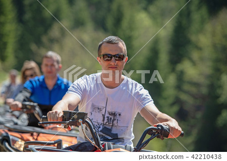 man riding atv vehicle on off road track ,people outdoor sport activitiies theme 42210438