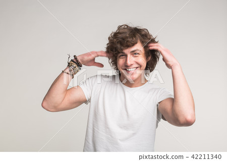 Happy handsome young man with moving arms on white background 42211340