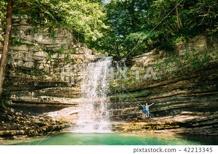 Young People Enjoy Nature Near Small Waterfall In Okatse River.  42213345
