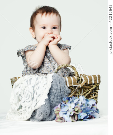Happy baby girl with flowers. Cute little child Happy baby girl with flowers. Cute little child 42213642