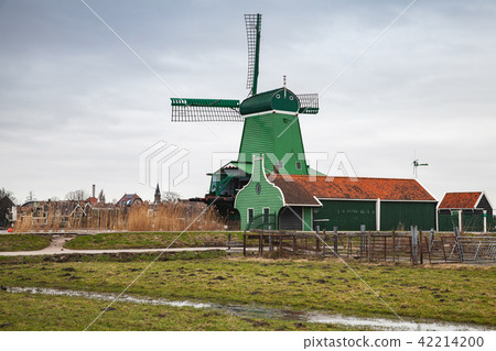 Old wooden Windmill near green barns Old wooden Windmill near green barns 42214200