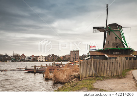 Windmill on river coast, Netherlands 42214206