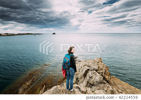 Young Woman Backpacker Hiker Enjoying Sea View On Top Of A Coast Young Woman Backpacker Hiker Enjoying Sea View On Top Of A Coast 42214559