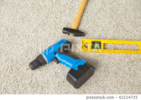 Hammer, drill and builders level on the floor 42214735
