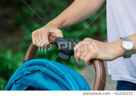 Overhead shot of young mother strolling a carriage Overhead shot of young mother strolling a carriage 42220152
