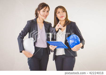 Two business women industrial engineers helmets 42224018