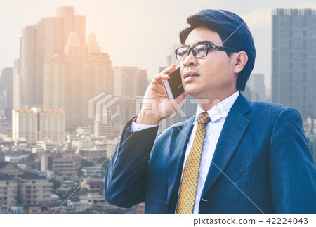 businessman in suit using smartphone at city businessman in suit using smartphone at city 42224043