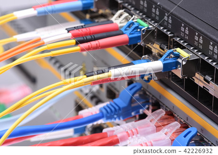 Fiber optic and network cables in data center 42226932