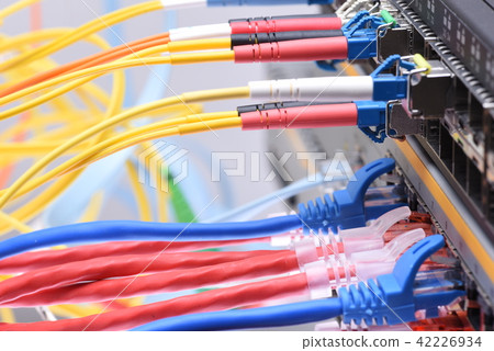 Fiber optic and network cables in data center 42226934