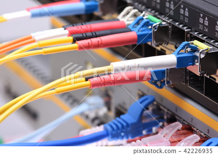 Fiber optic and network cables in data center Fiber optic and network cables in data center 42226935