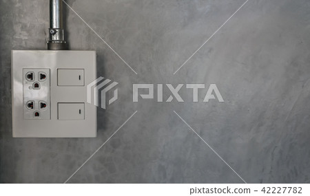 electric plug and switch on gray wall electric plug and switch on gray wall 42227782