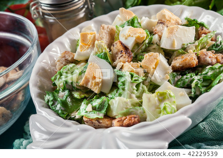 Caesar salad with chicken, eggs and croutons 42229539