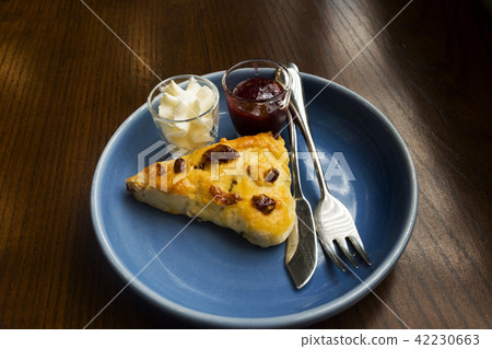 Desserts, scones, berries on a wooden table. 42230663