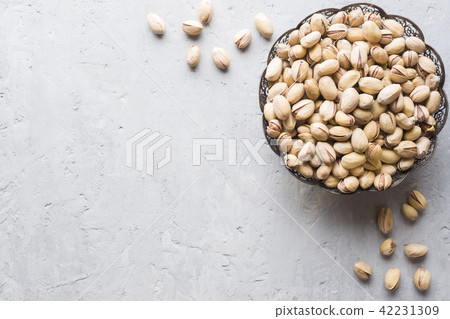 Delicious salted pistachios on a plate Copy space Delicious salted pistachios on a plate Copy space 42231309