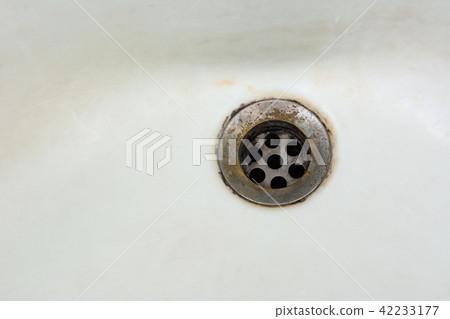 old and dirty wash basin drain outlet in bathroom 42233177