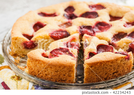 pie with plums and slice and cup with coffee pie with plums and slice and cup with coffee 42234243