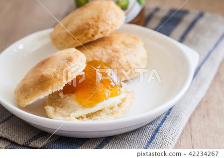 scones with butter and jam on a napkin and Bank scones with butter and jam on a napkin and Bank 42234267