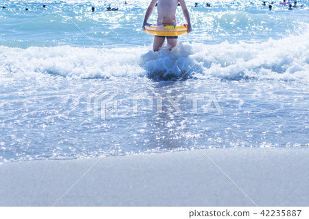Child with a circle in the water Child with a circle in the water 42235887