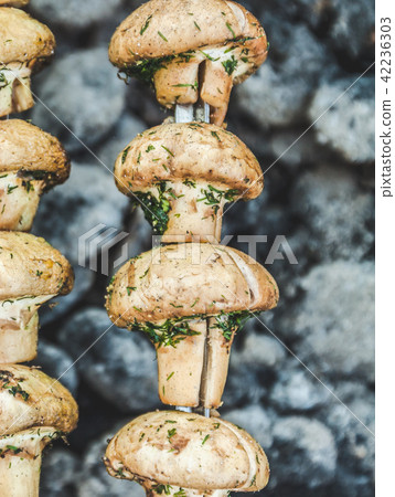 Grilled mushrooms cooked in a brazier, top view Grilled mushrooms cooked in a brazier, top view 42236303