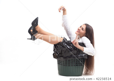 Crazy woman sitting in trash can. Crazy woman sitting in trash can. 42238514